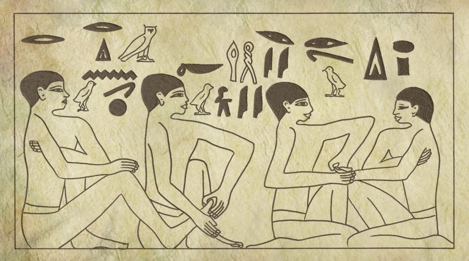egipska płaskorzeźba przedstawiająca dwóch mężczyzn masujących stopy dwóch innych mężczyzn