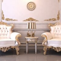 Dwa luksusowe fotele a pomiędzy nimi stolik z lampką