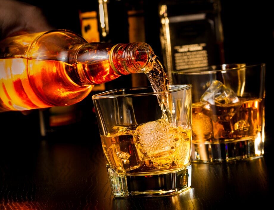 Barman nalewa whisky do szklanek