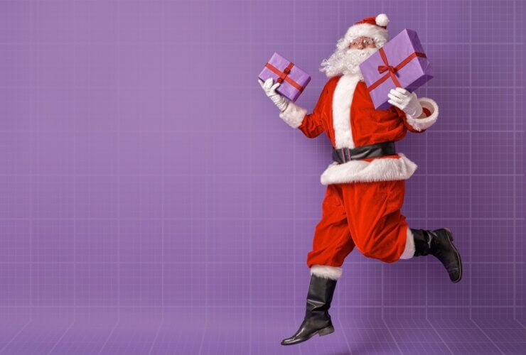 Święty Mikołaj z prezentami na fioletowym tle